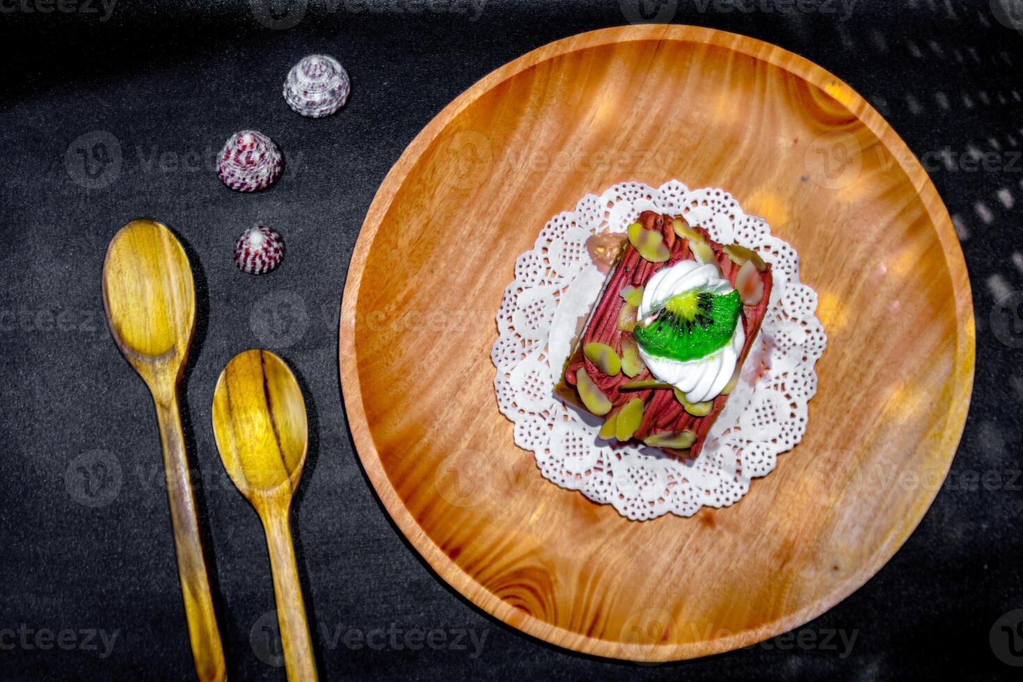 A plate with a dessert on it and a spoon photo