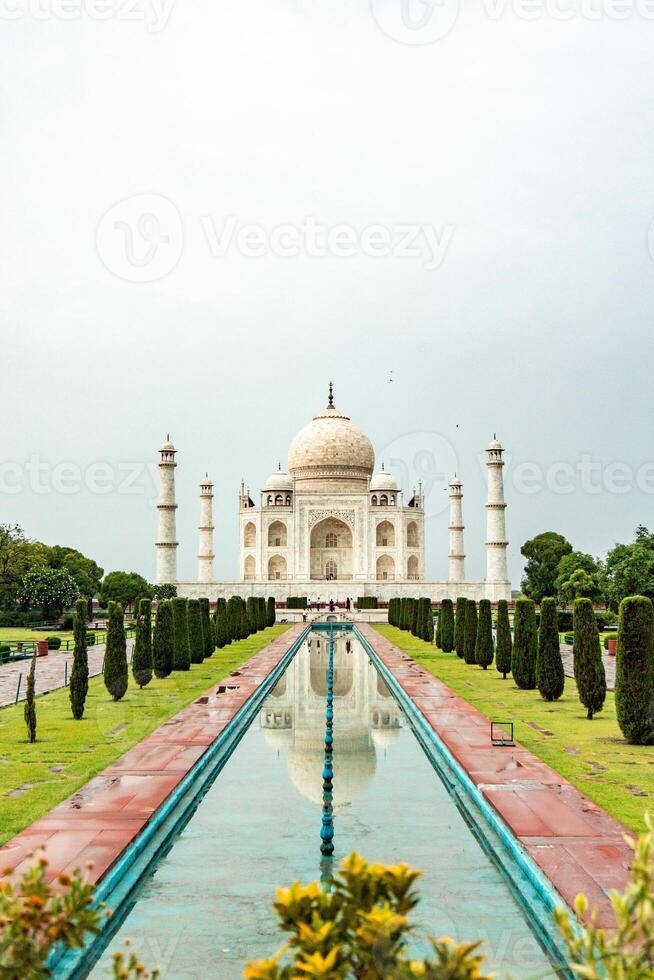 Taj Mahal reflecting in the water pool in Agra, India photo