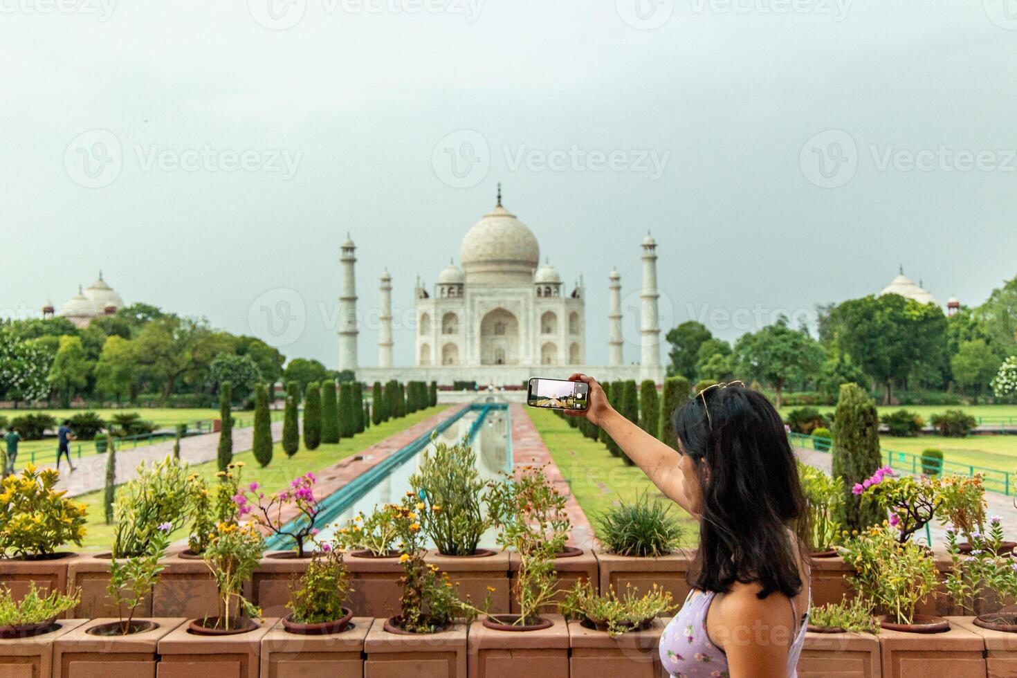 latin Tourist taking photo of Taj Mahal in Agra, India
