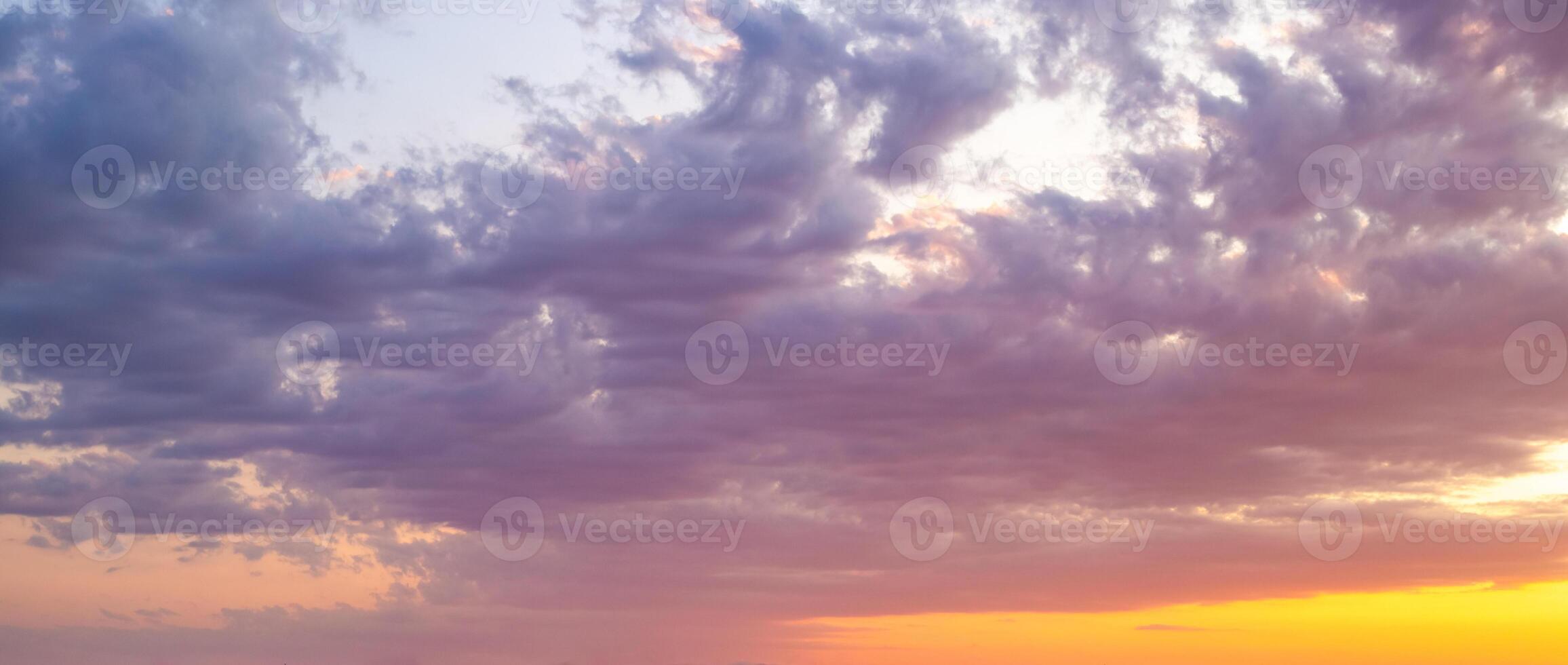 Skyscape, panorama. Vibrant colorful sky at sunset with a mix of purple, orange and blue hues photo