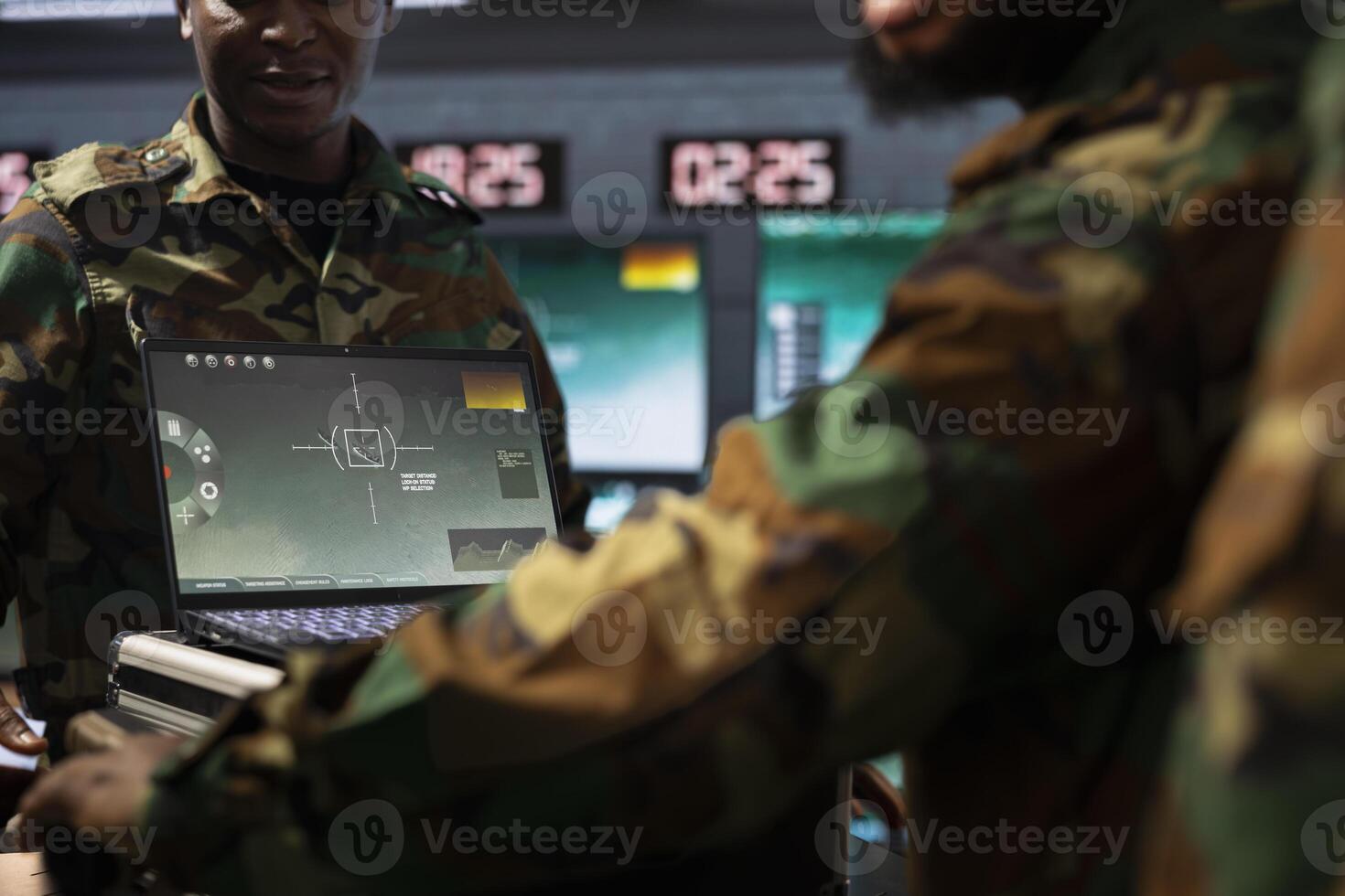 Military officers operating aerial systems on laptop device to support reconnaissance and target identification. Army specialists monitoring counterinsurgency operations with notebook software photo