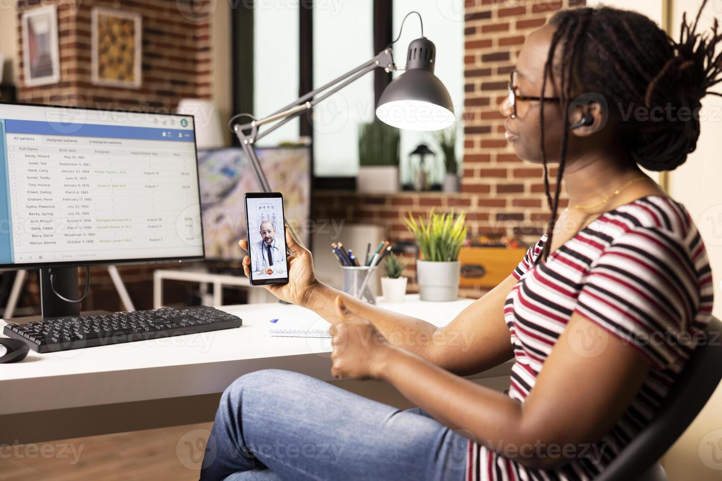 Female data analyst in virtual meeting with caucasian doctor, discussing updates to hospital digital system. Black woman consulting with physician through call during healthcare database session photo