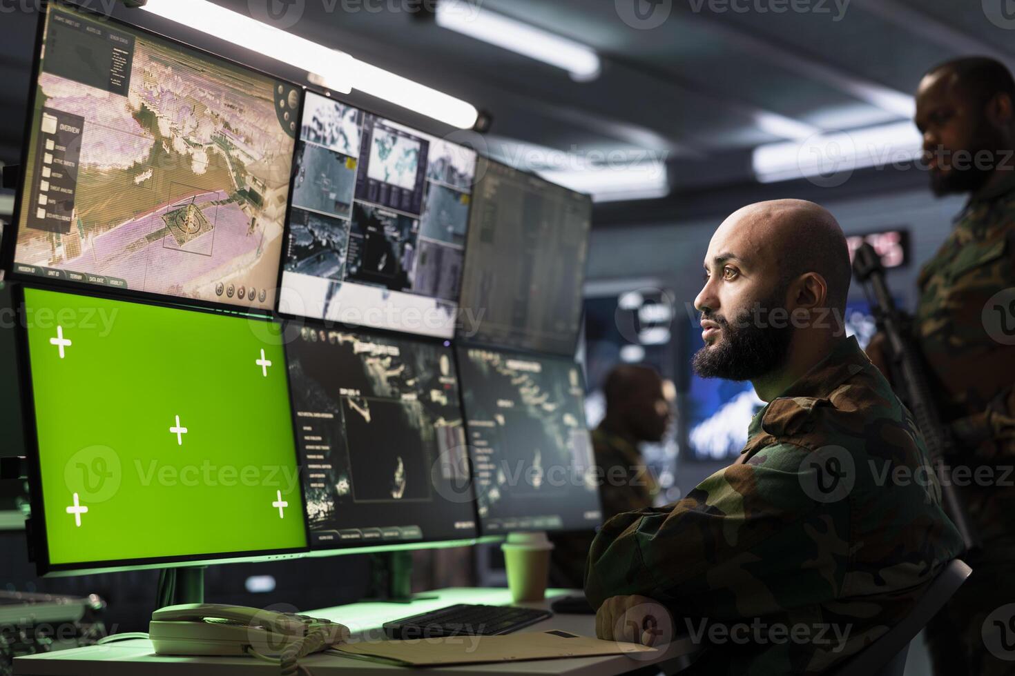 Counterterrorism division operative using target acquisition tech on isolated screen gear to detect enemy location. Defense security expert using chroma key satellite hardware to track threats photo