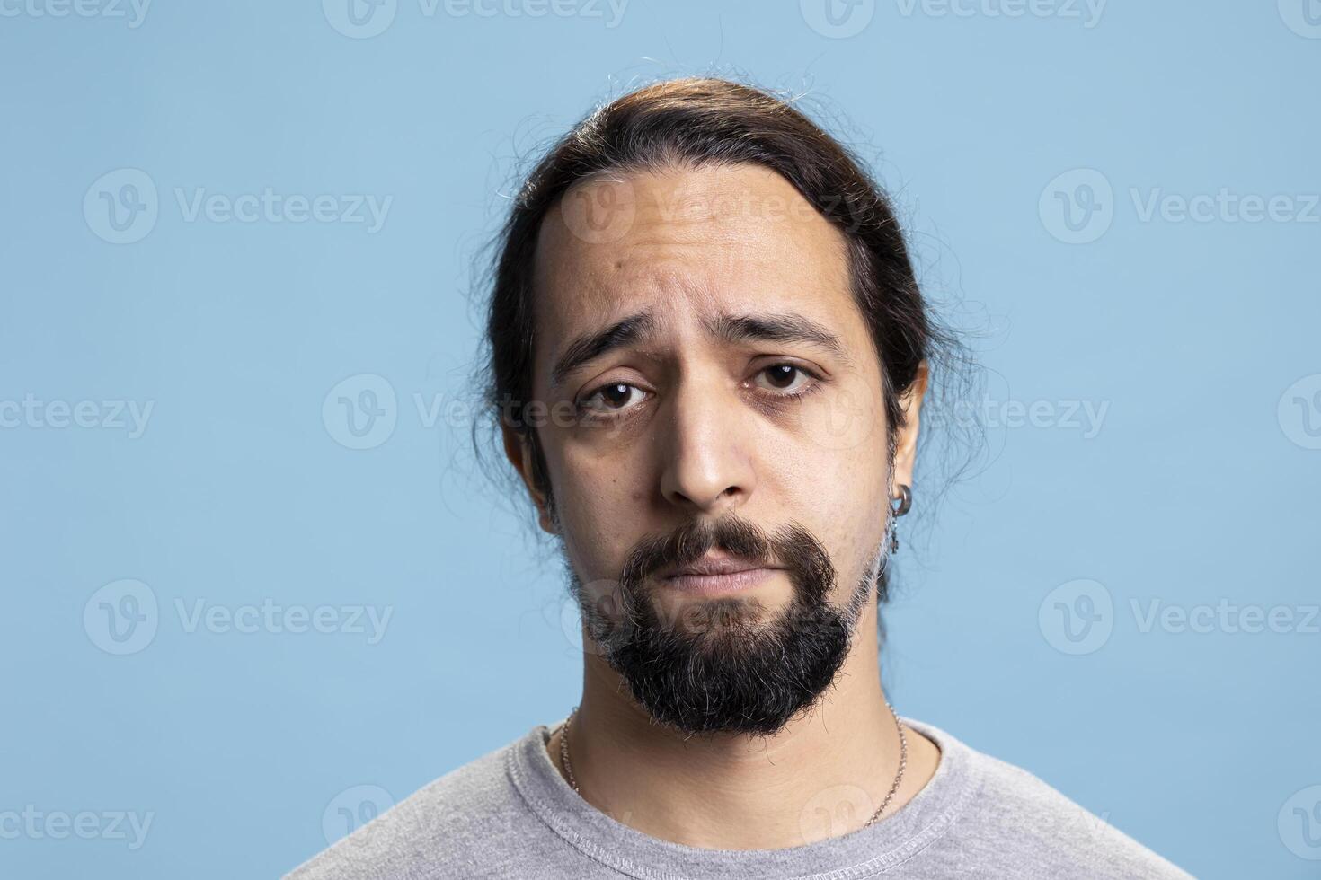 Disappointed sad tired guy feeling distressed and discouraged on camera, dealing with low self esteem and emotional crisis. Depressed unhappy person suffers from anxiety or grief. photo