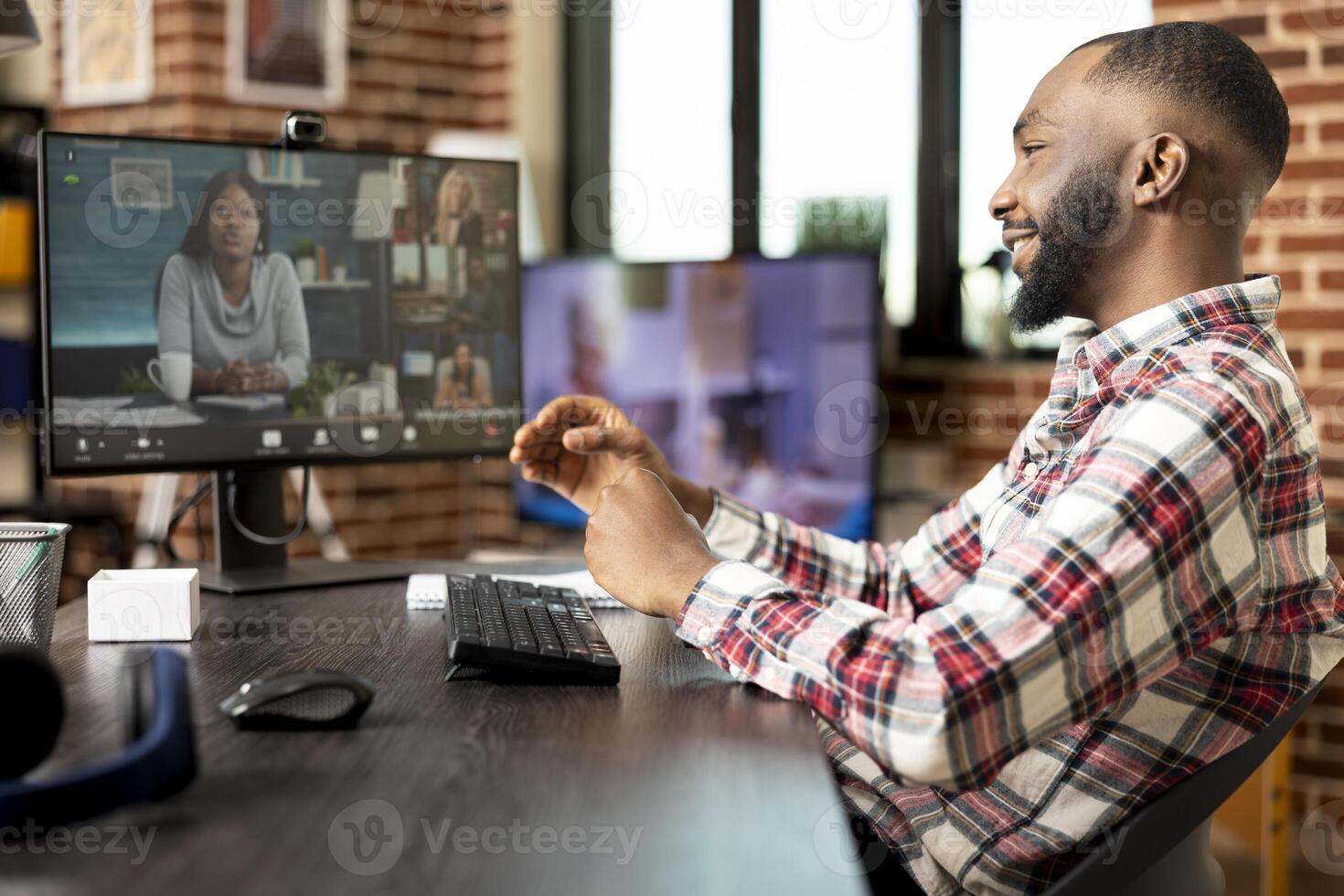 Smiling businessman working remotely from cozy apartment, attending virtual conference with colleagues on desktop pc. Freelancer discussing startup projects during online meeting with investors. photo