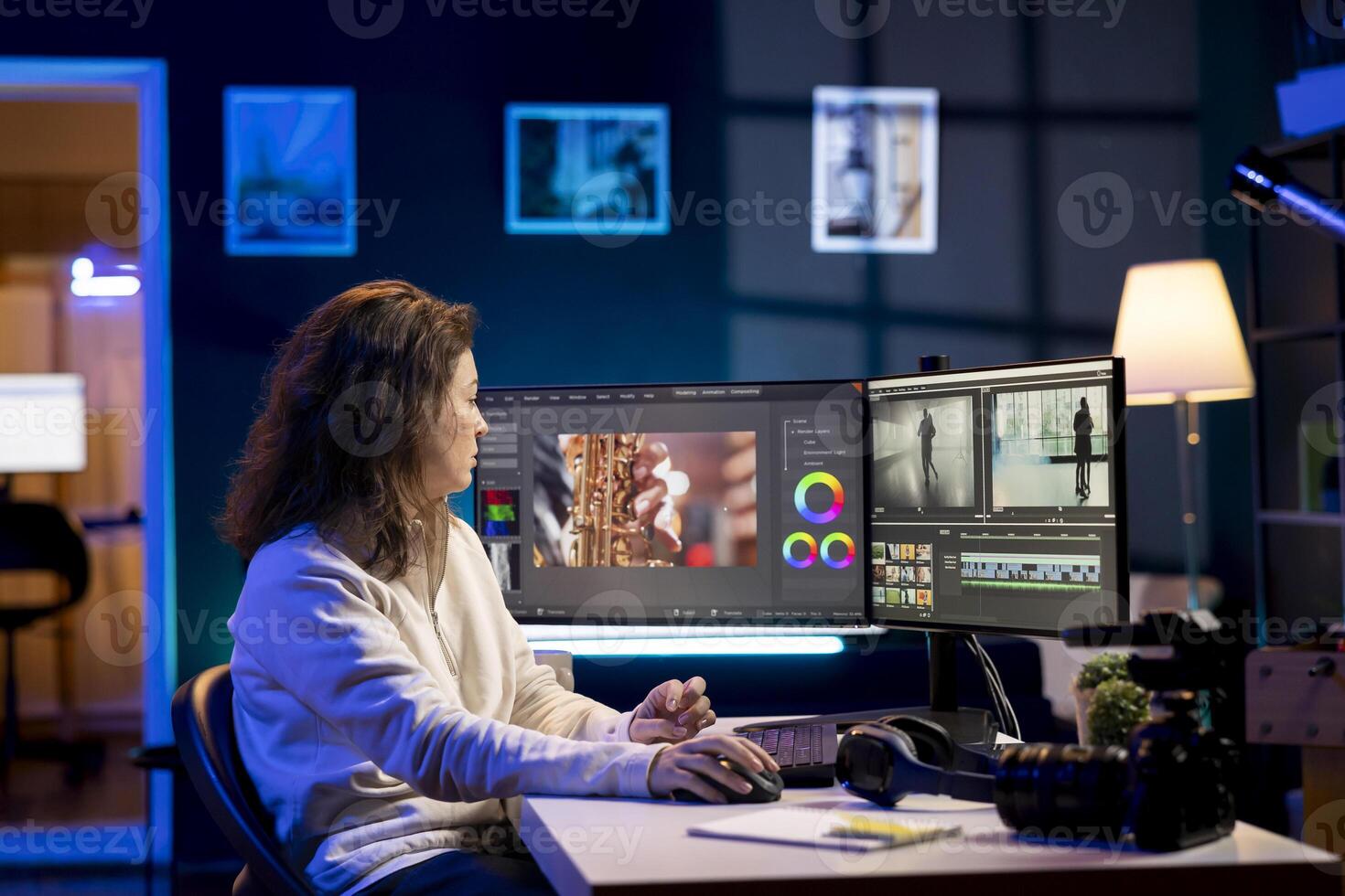producer adds sound effects to film montage, working in studio. Videographer using headphones to test and improve audio quality using specialized software on computer photo