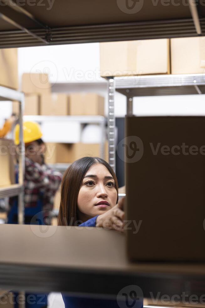 Asian female staff at a small business supply room handles merchandise and prepares shipments, ensuring local delivery. Local brand operations include express delivery, inventory tracking. photo