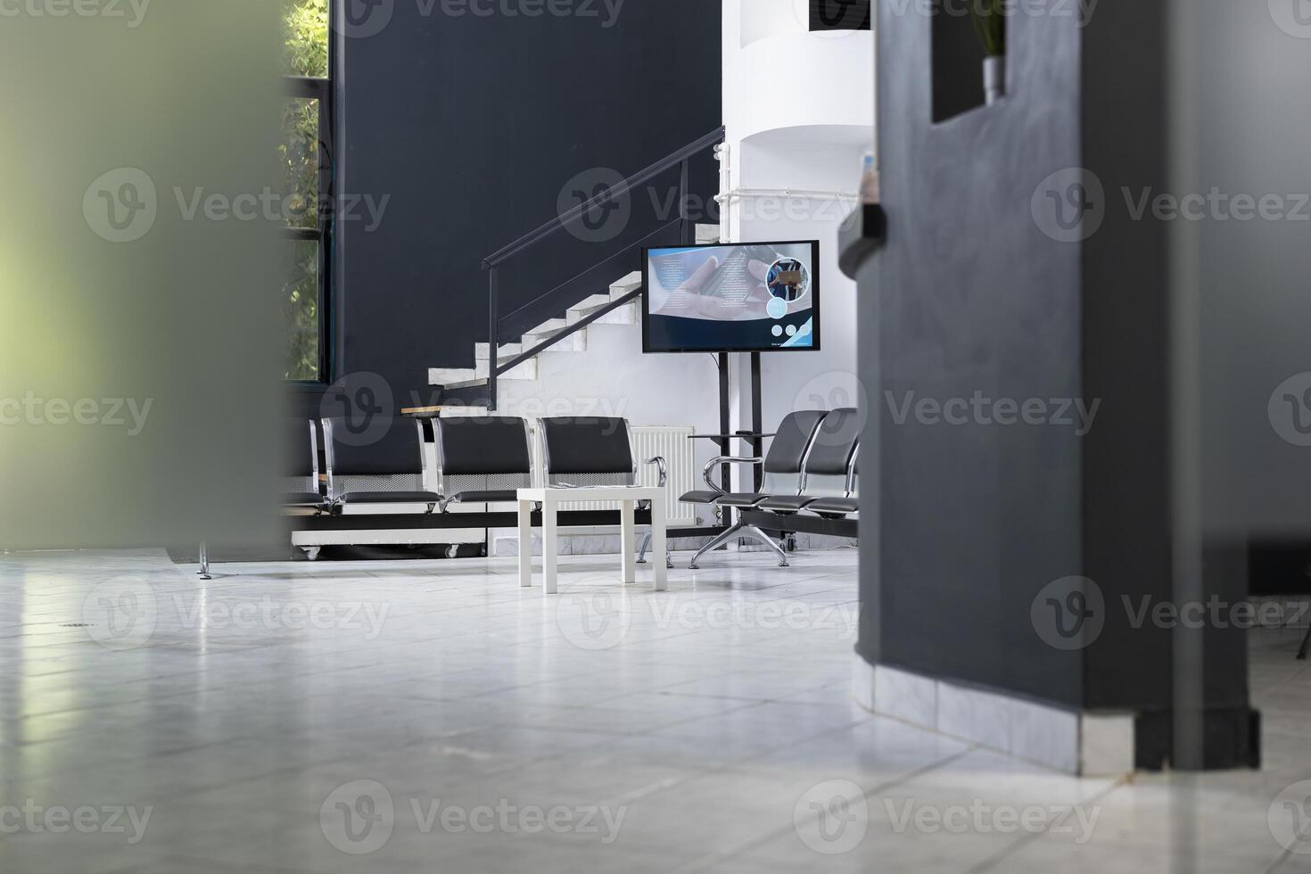 Bright clean and empty clinic waiting area featuring modern hallway, medical equipment and urban lifestyle design with organized seating in a professional healthcare facility. Medical lounge. photo