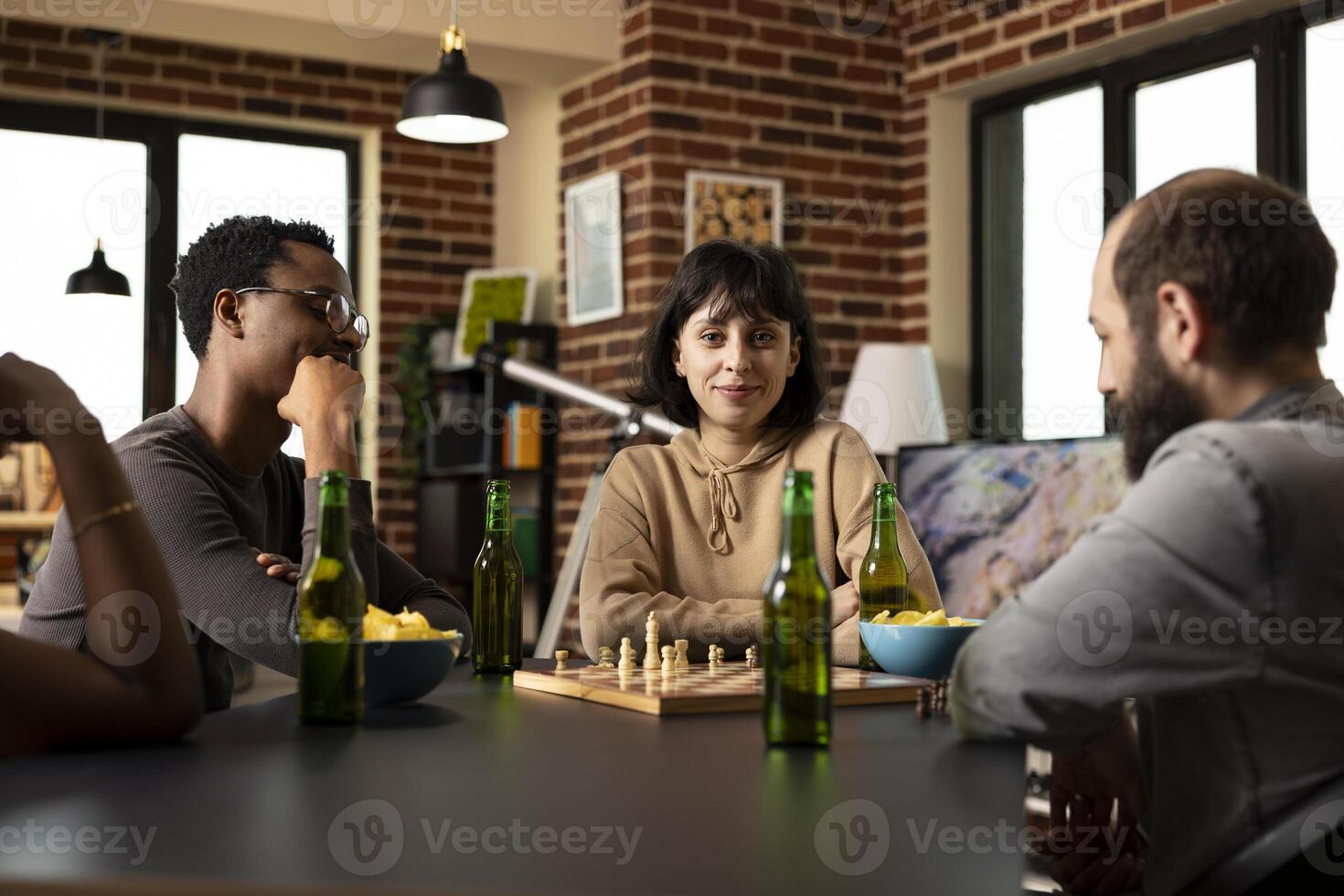 Friends playing chess at a table photo