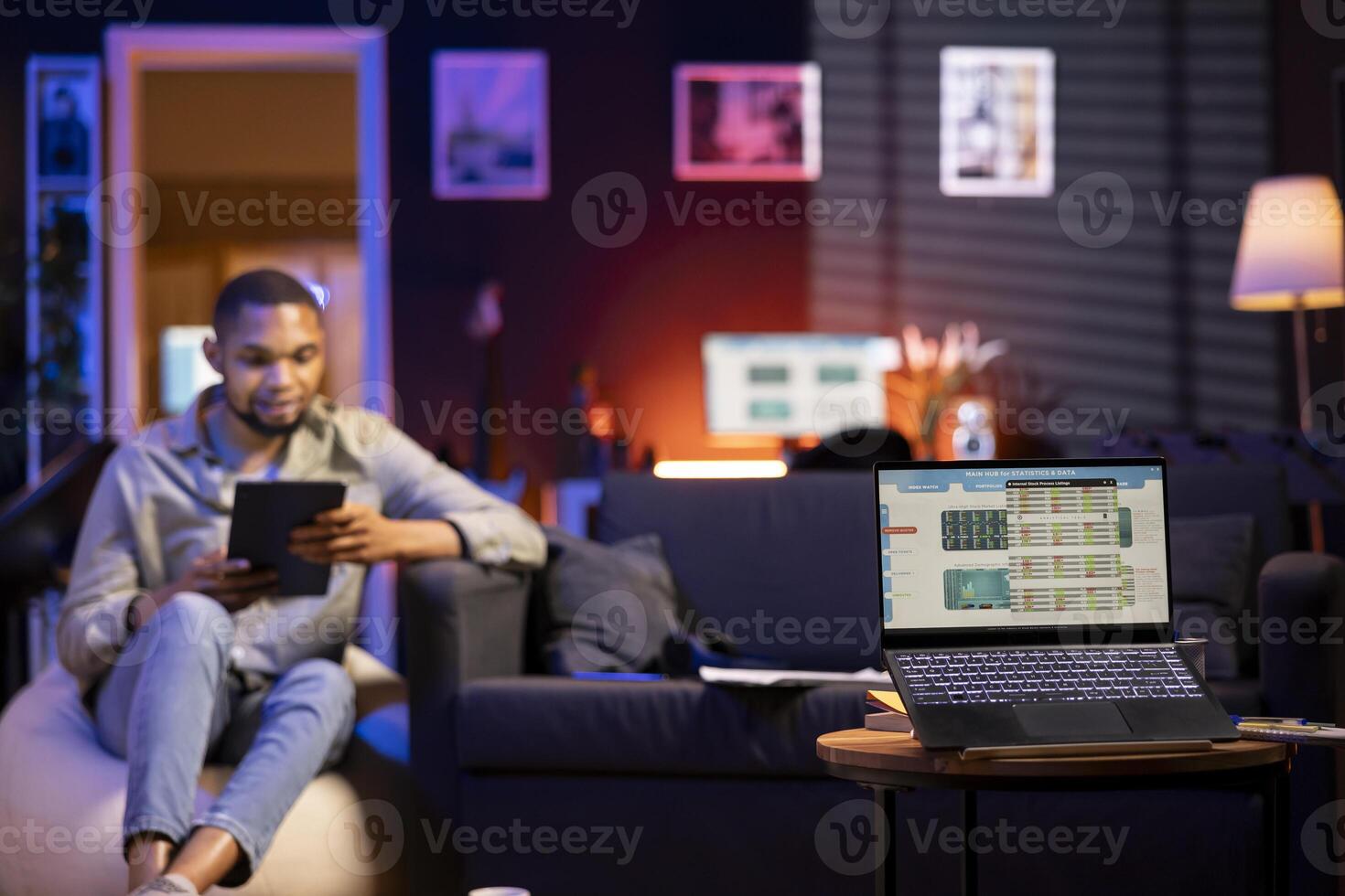 man using tablet in cozy workspace photo