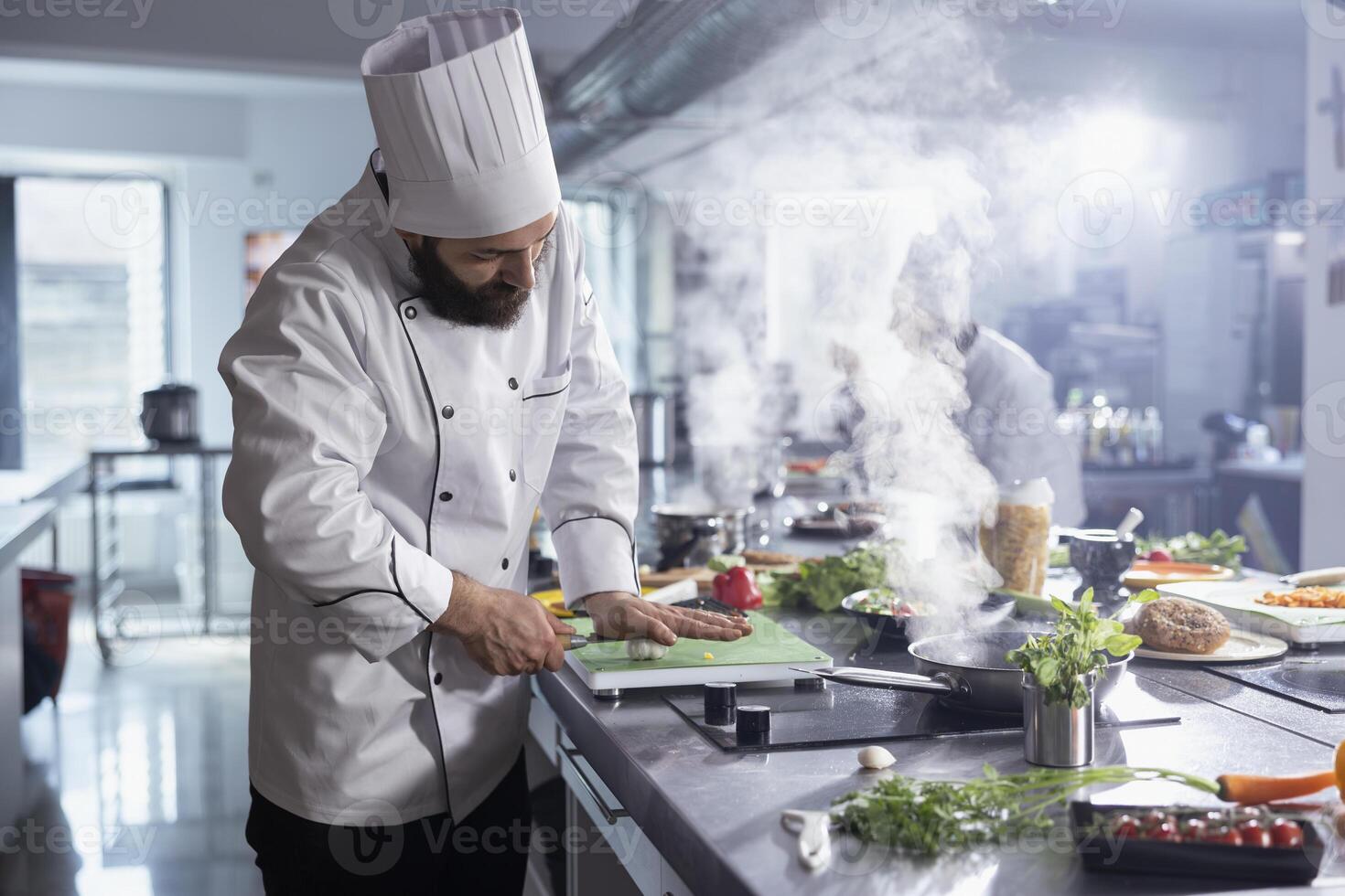 Chef chopping vegetables in kitchen photo