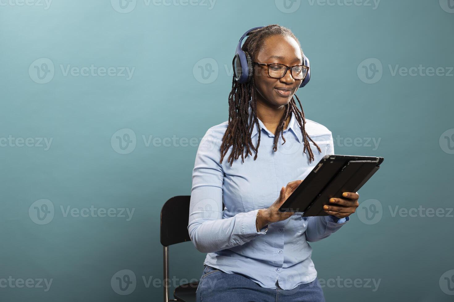 Woman with tablet and headphones photo