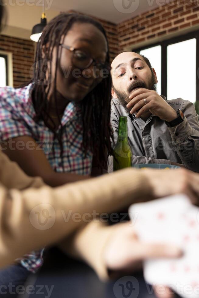 Friends enjoying a card game together photo