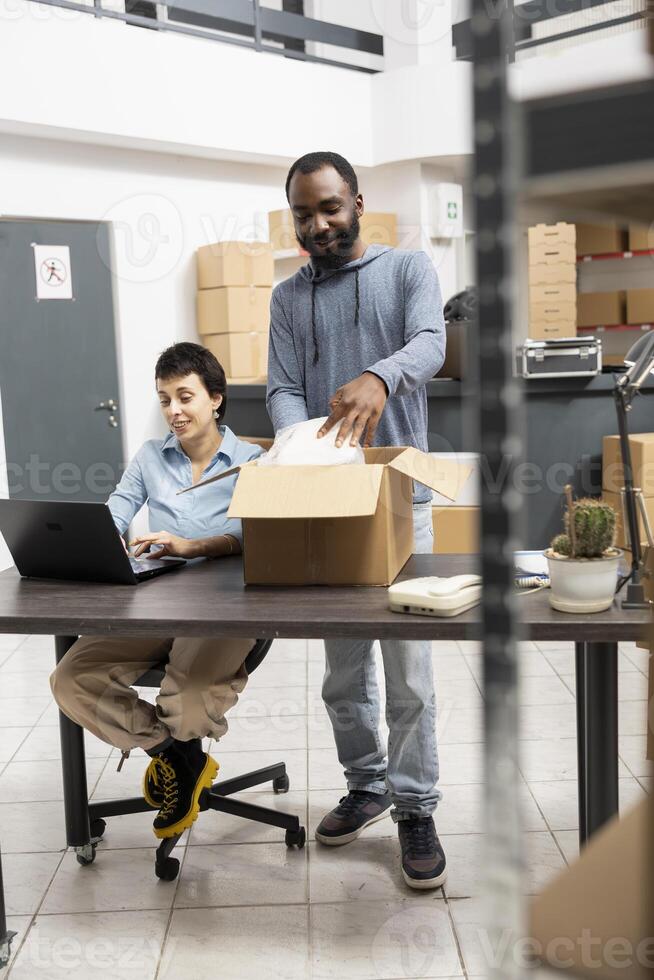 Office team with shipment box and laptop photo