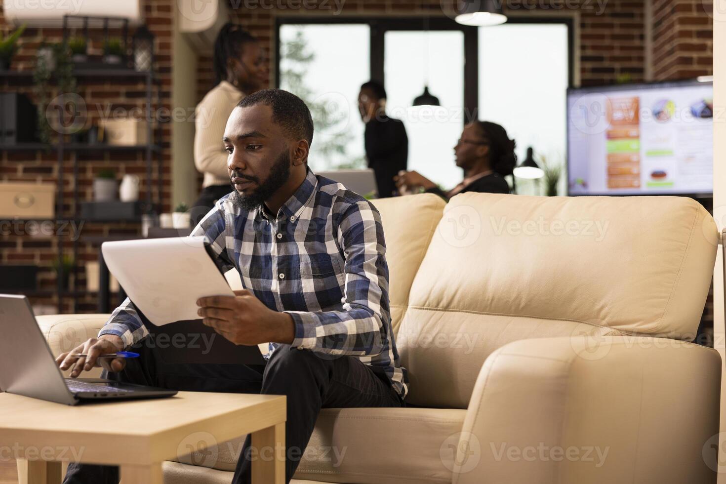 Man working on laptop in office photo