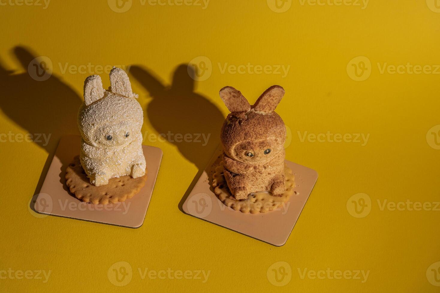 Cute Labubu character-shaped cakes on round biscuits with shadows, studio shot on yellow background photo