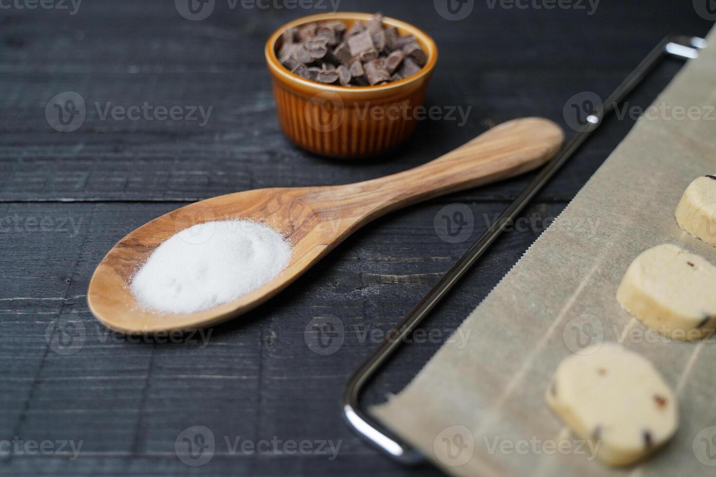 Ready to bake cookie dough with chocolate chips and sugar spoon photo
