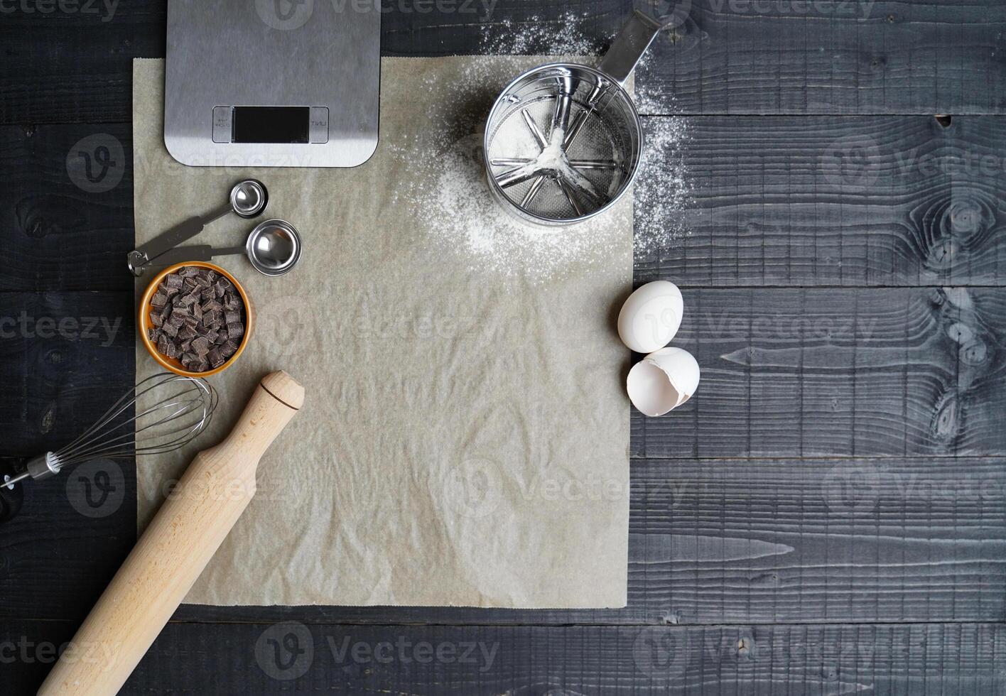 Baking Tools on Black Wood with Parchment Paper photo