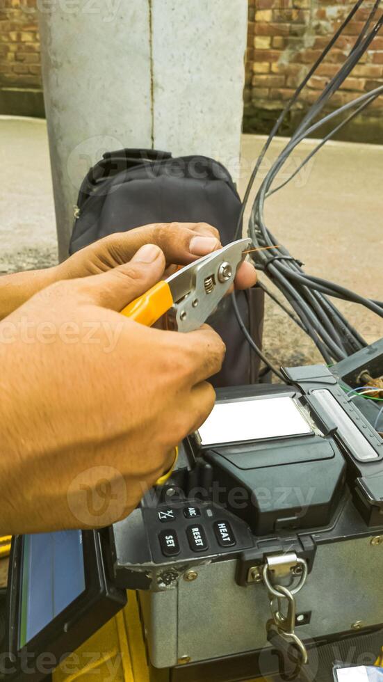 Fiber Optic Cable Splicing Technician Using Modern Fusion Splicer Tool photo