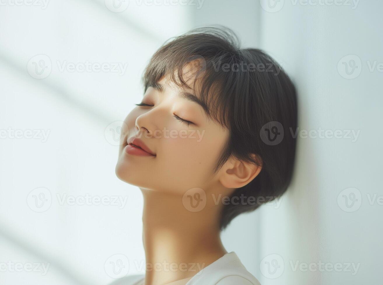 Asian woman with closed eyes looking up at the sky photo