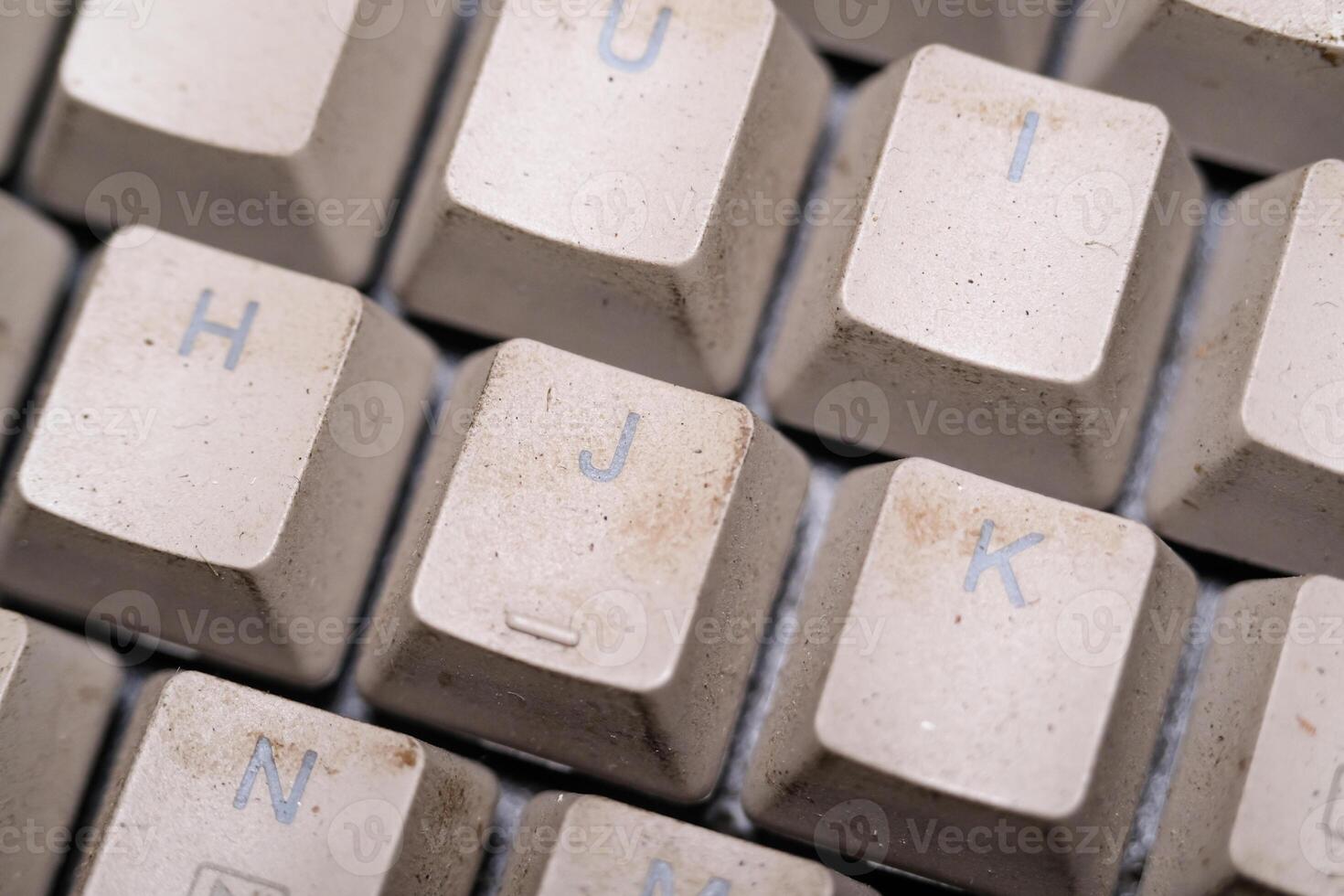 Close-up shot of square key caps in gray and black. Macro Photography of mechanical keyboard with two unique and cool colors. Dirty keycaps with dirt and crust closeup. Technology Backgrounds photo