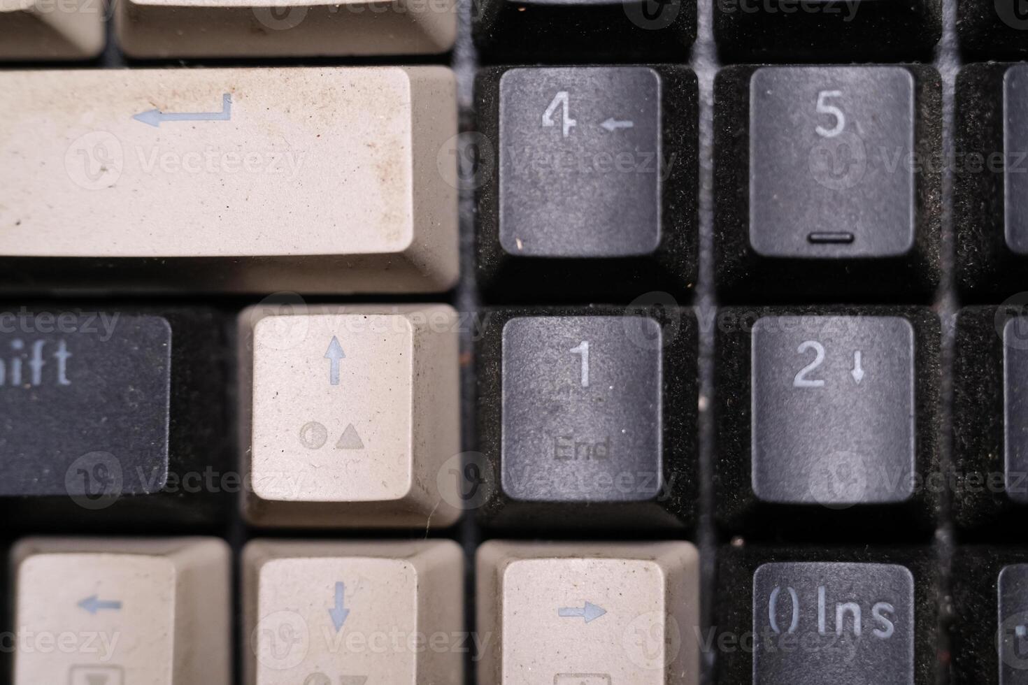 Close-up shot of square key caps in gray and black. Macro Photography of mechanical keyboard with two unique and cool colors. Dirty keycaps with dirt and crust closeup. Technology Background photo