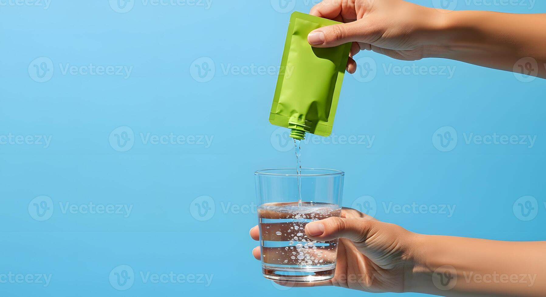 Effortlessly adding vibrant flavor to water, Simple hydration boost for a healthy lifestyle on a bright blue background photo