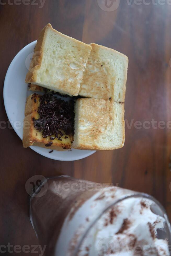 A sandwich and a drink on a table photo