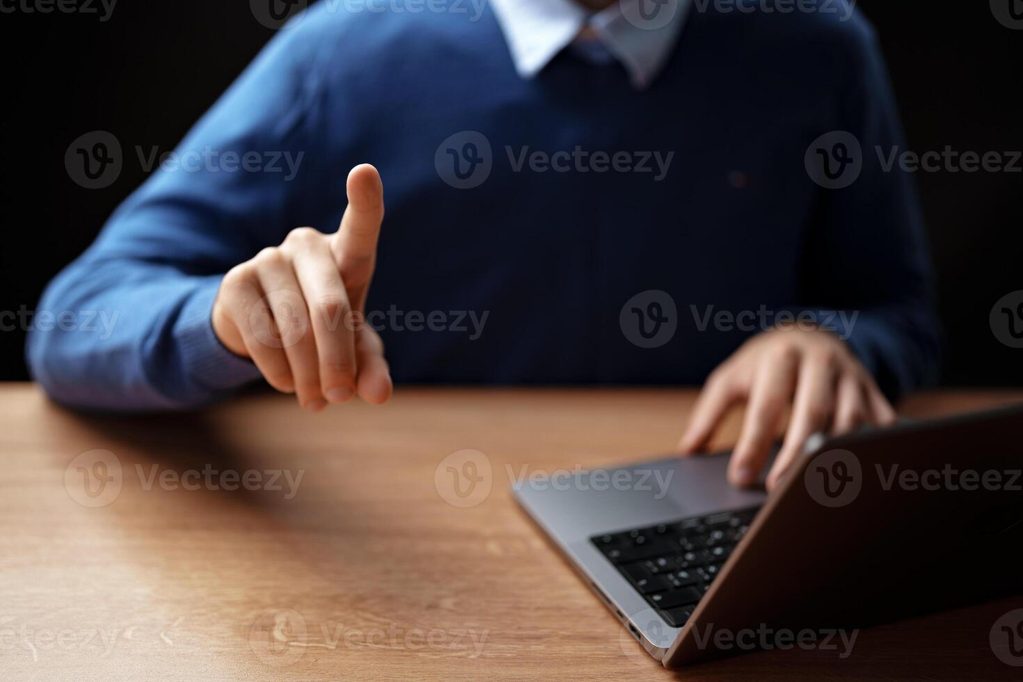 Individual gestures while using a laptop during a virtual meeting at home in the evening photo