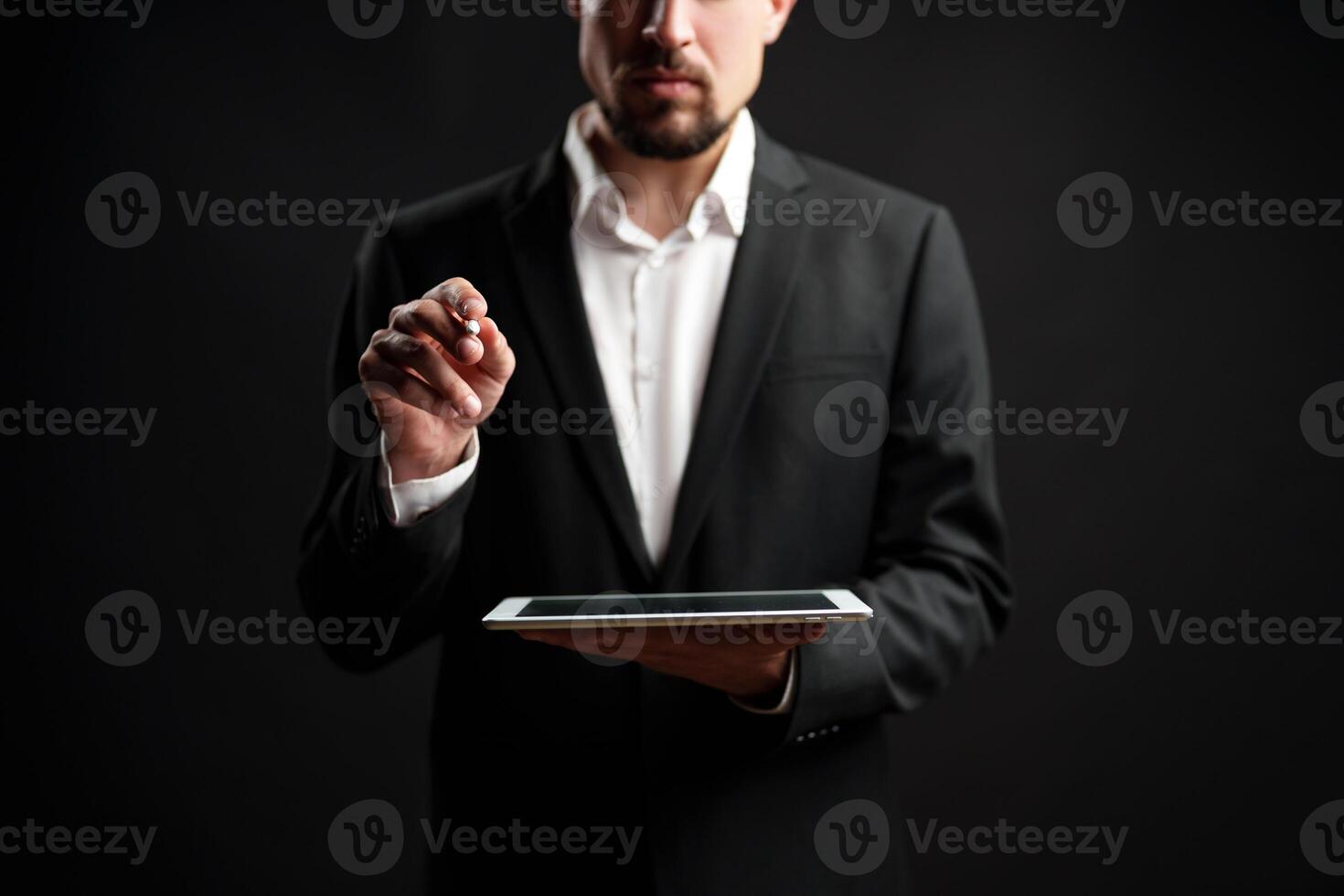 Business professional using a tablet in a dark studio for digital strategy and presentations photo