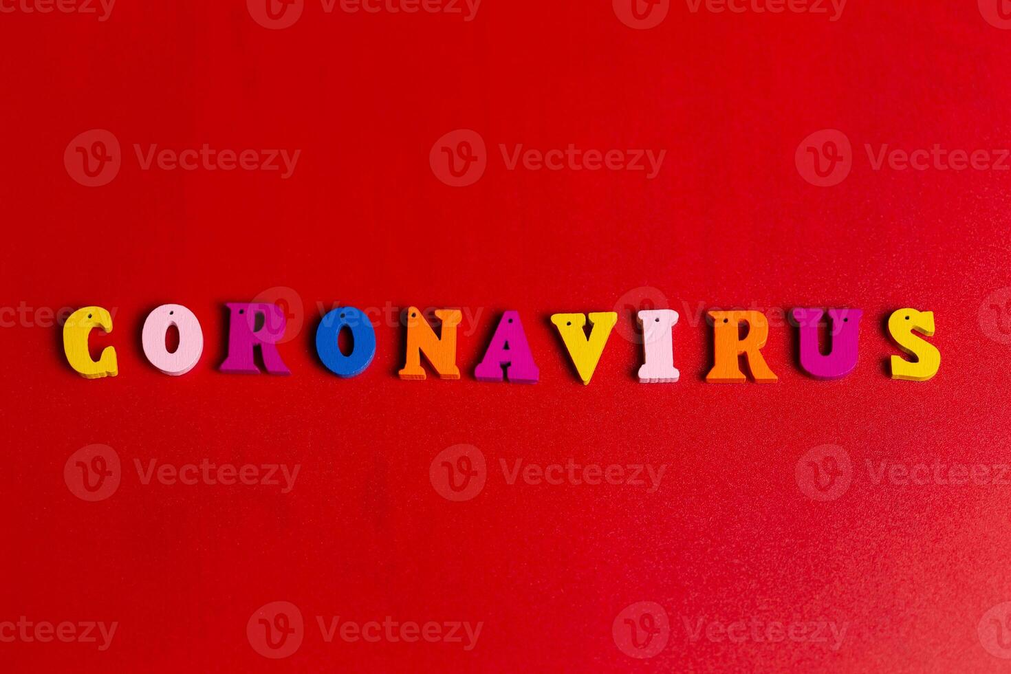 Pandemic and virus concept. Coronavirus word made of colourful blocks. Coronavirus text on red background. Coronavirus concept top view photo