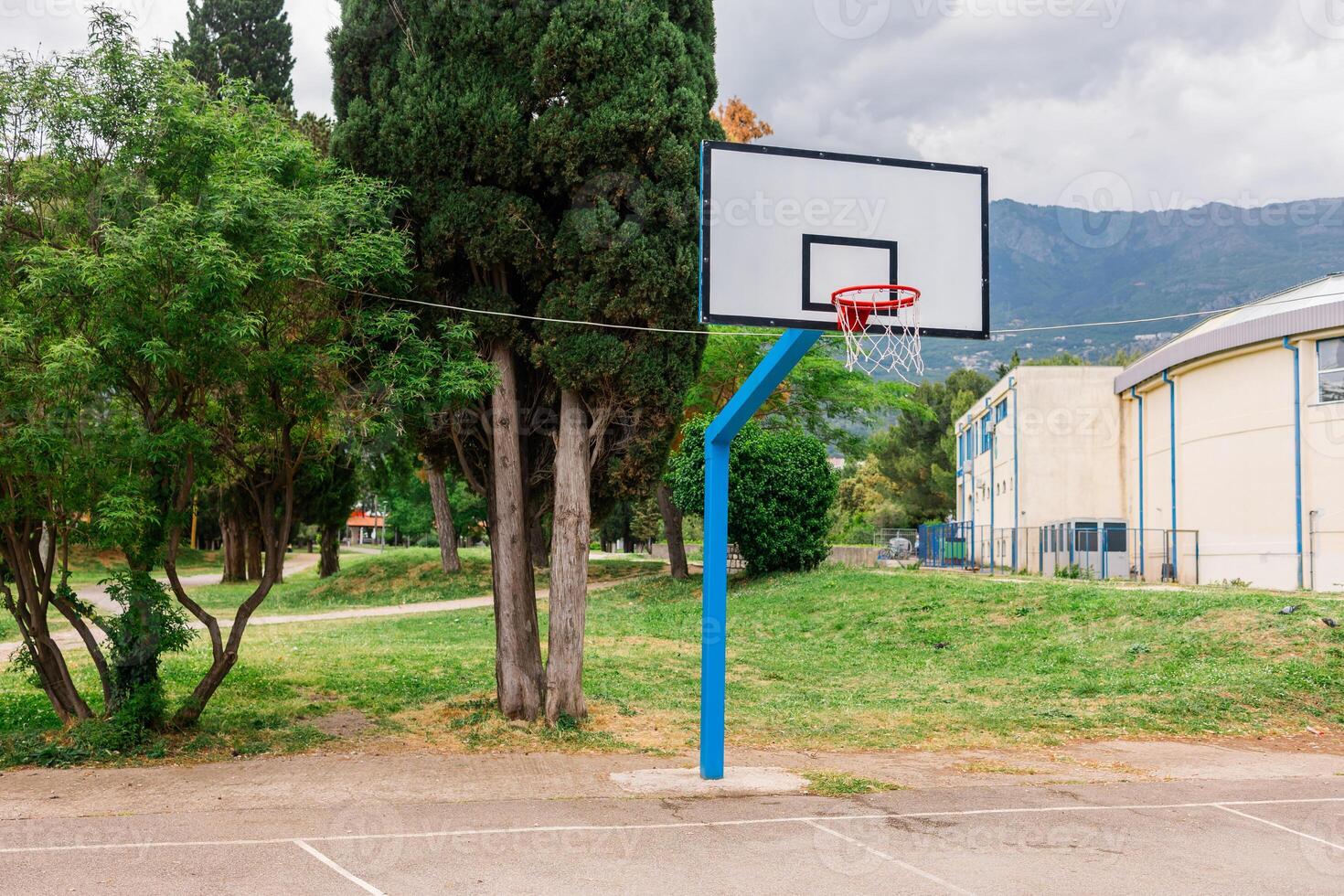 Outdoor basketball hoop in a public park. Urban recreation, sports activity, and healthy lifestyle in a community setting photo