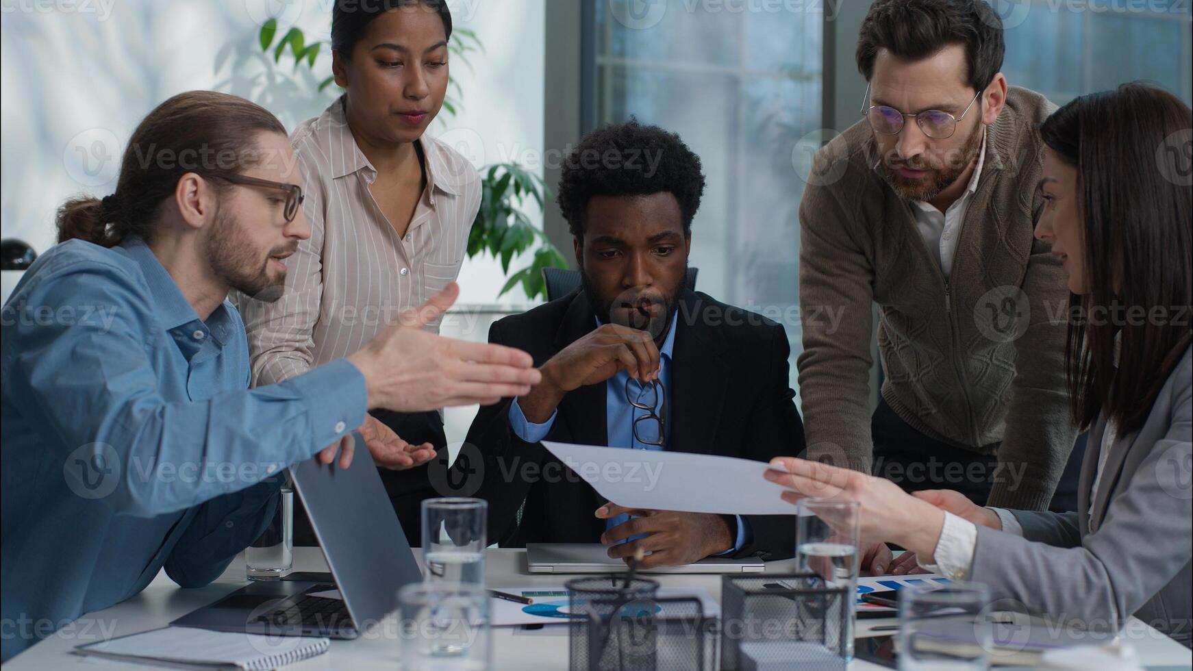 Business team multiracial group talking discussion graph chart document report analyzing men women in office coworkers African American Indian Caucasian businesswomen businessmen solve plan strategy photo