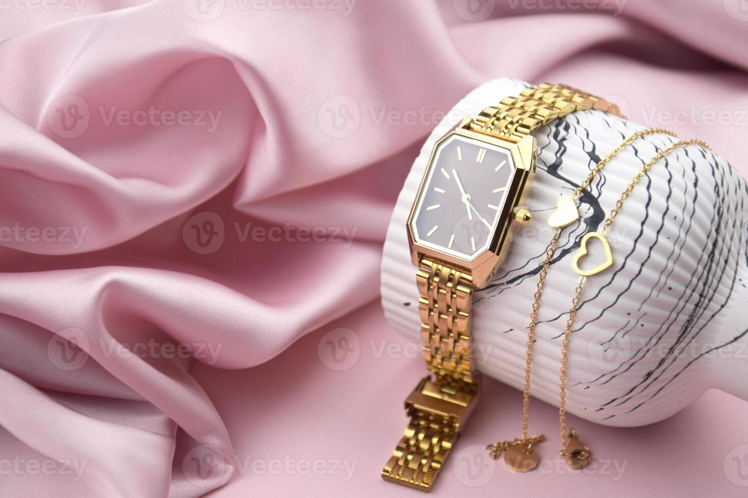 Closeup minimal fashion green wristwatch for women on the pink background. photo