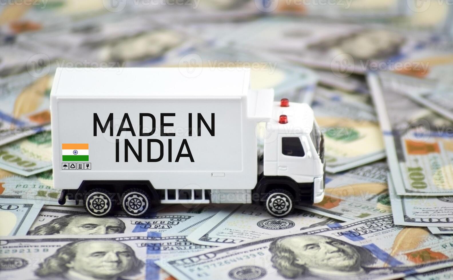 A white truck and dollars with the inscription made in India. photo