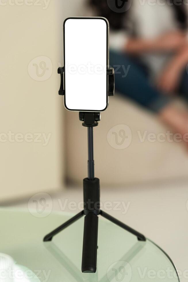Blank smartphone tripod setup for content creation. Device is isolated for mockup or presentation use in digital projects. photo