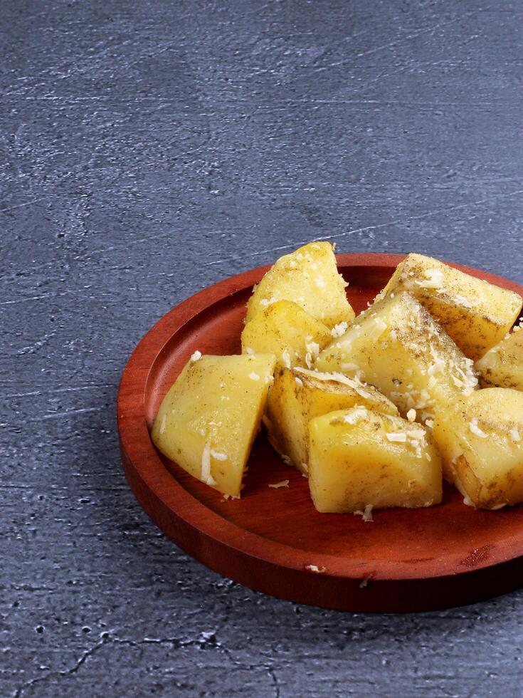 Cooked potatoes with cheese garnish photo