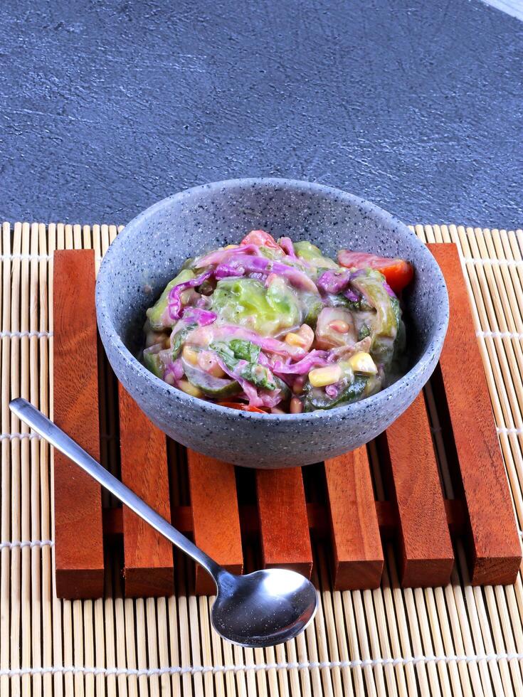 Healthy salad in a stone bowl photo