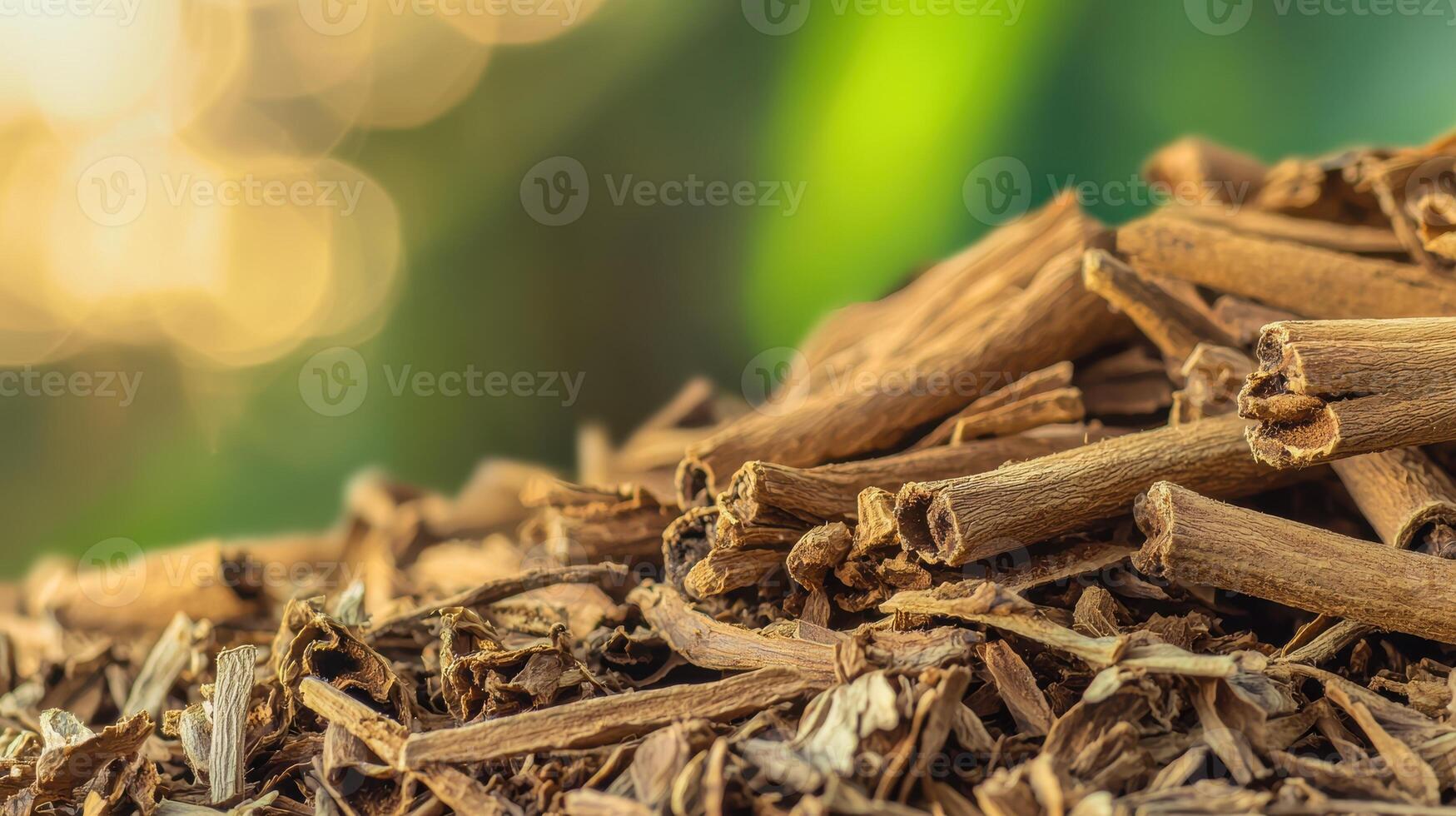 Pile Of Dried Cinnamon Sticks With Blurred Green Background. Aromatic Spice For Culinary And Medicinal Uses photo