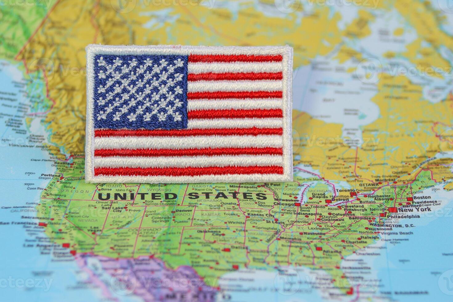 Eco friendly embroidered United States flag on world map at Washington DC. Perfect for themes of travel, national day, climate change and eco design photo