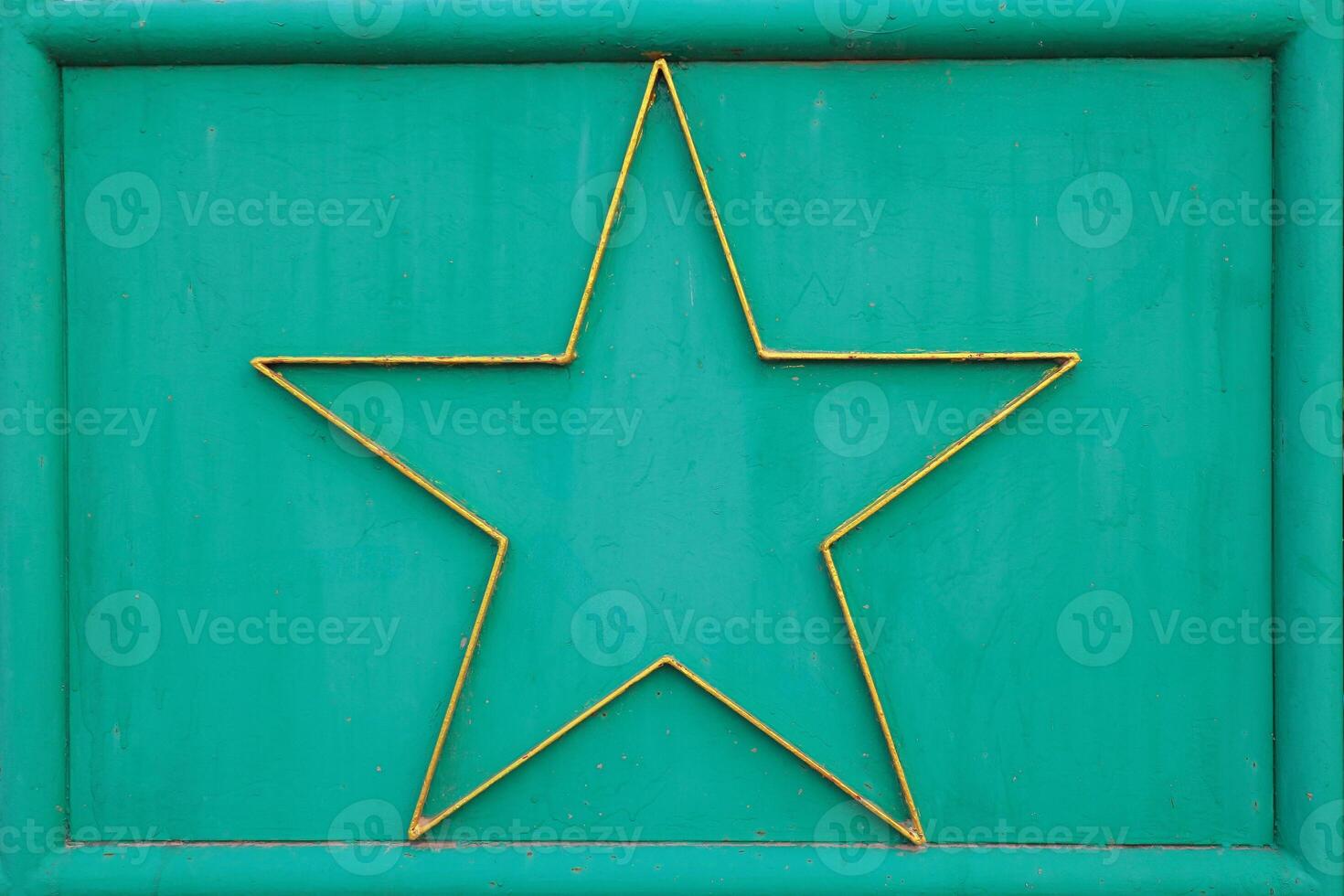 Abstract horizontal texture featuring green metal surface with decorative gold star framed at center. Vintage industrial look ideal for design, art or backgrounds. photo