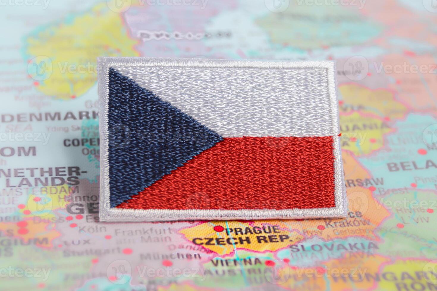 Horizontal shot of Czechia national flag and CZ flag embroidered with thread, placed on world map at Prague Czechia. Represents travel, patriotism and cultural heritage. photo