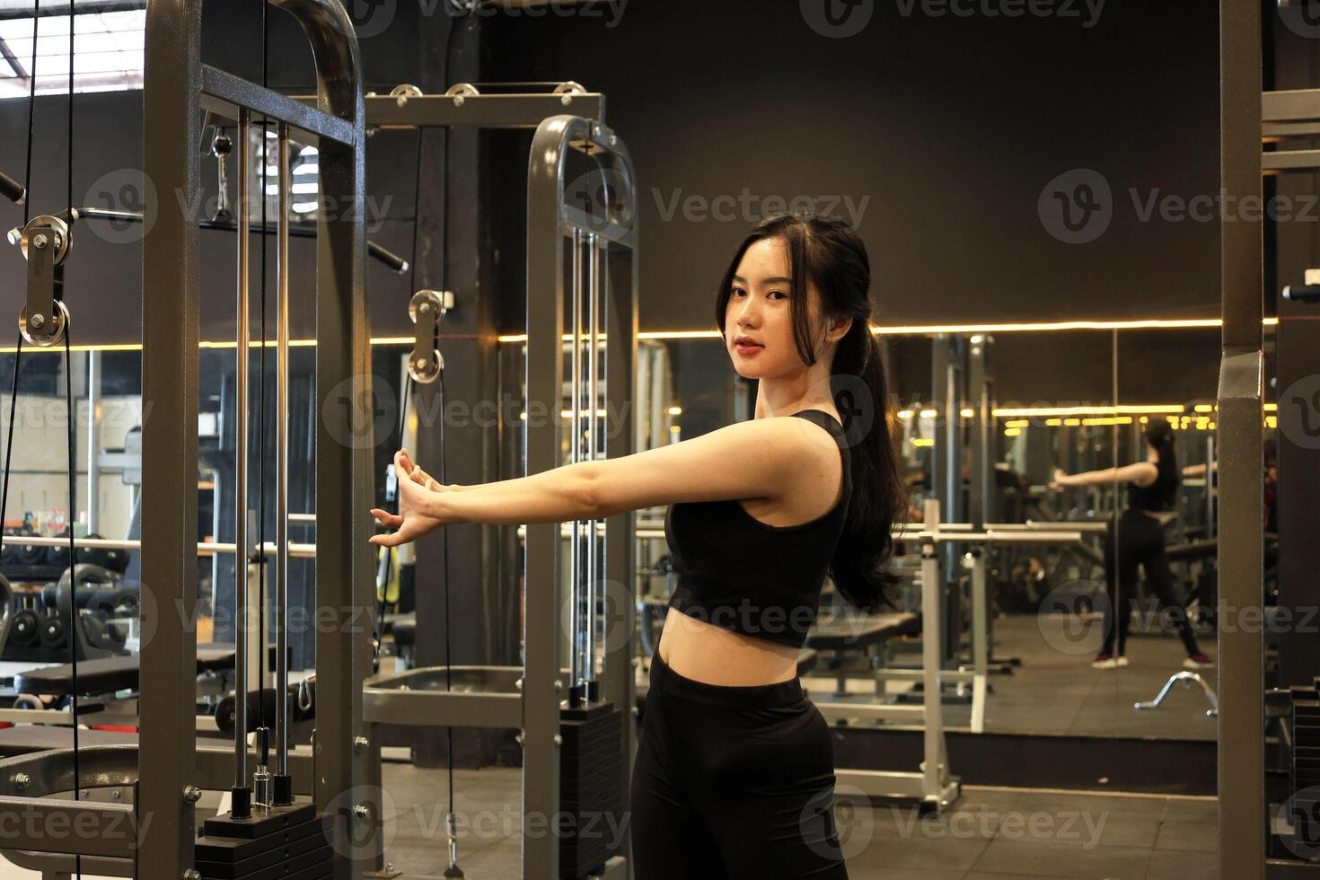 Young Woman Stretching at the Gym photo