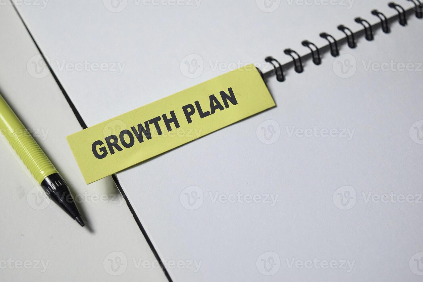 Concept of Growth Plan write on sticky notes isolated on Wooden Table. photo