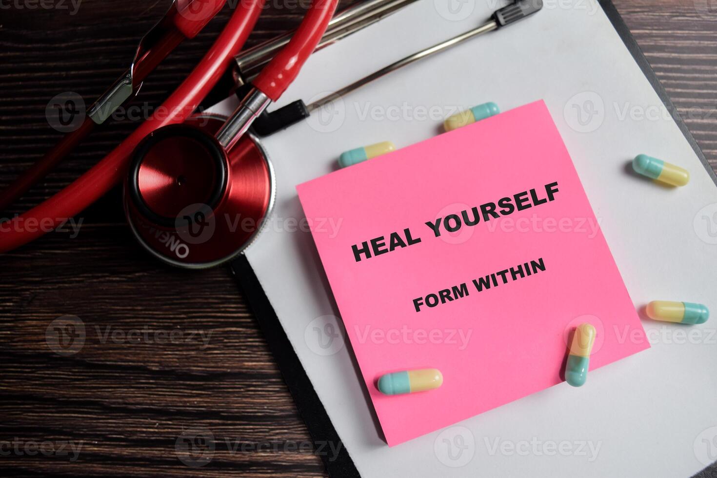 Concept of Heal yourself from within write on sticky notes isolated on Wooden Table. healthcare and pharmaceutical concept photo