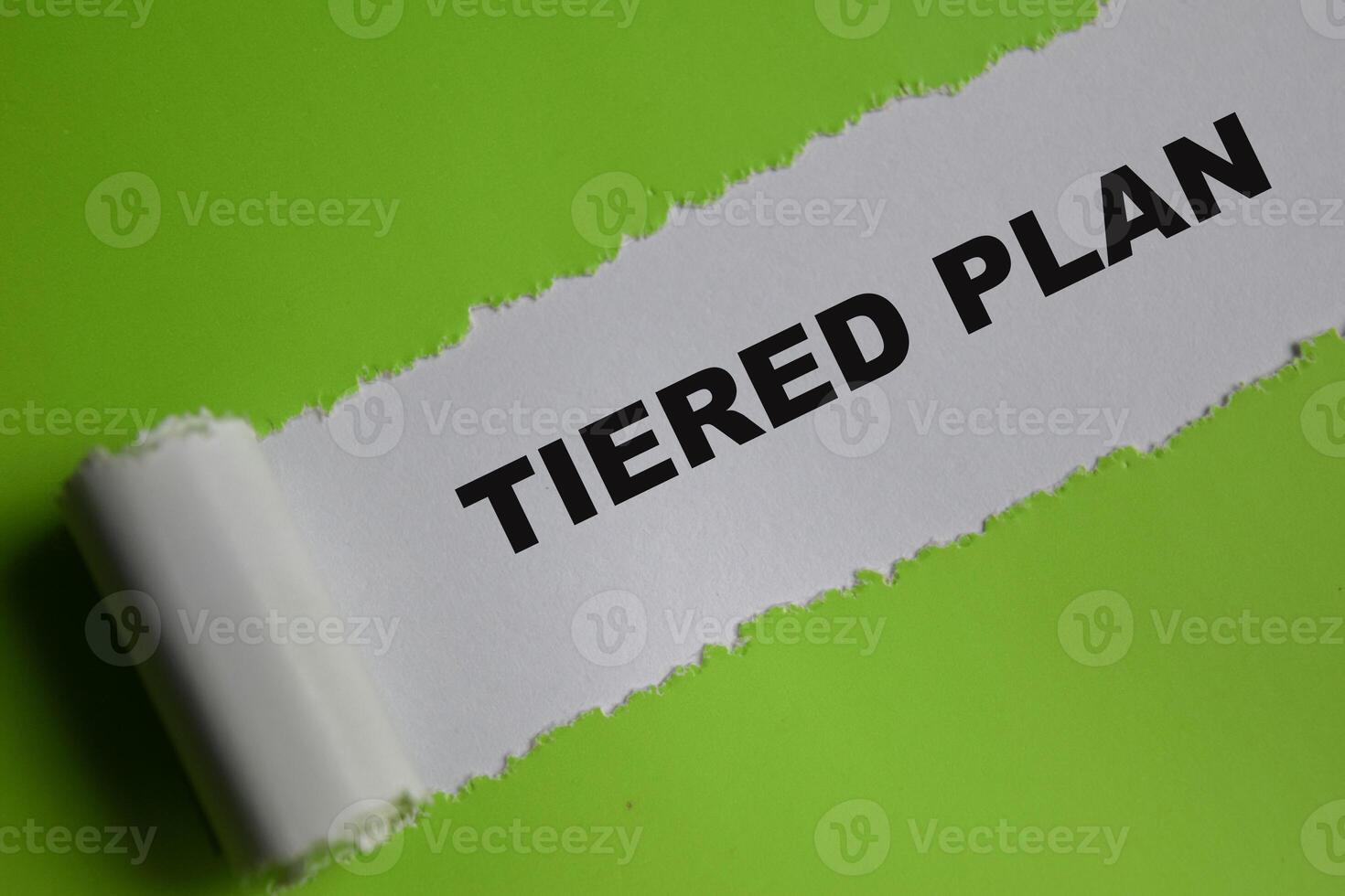 The tiered plan Text written in torn paper photo