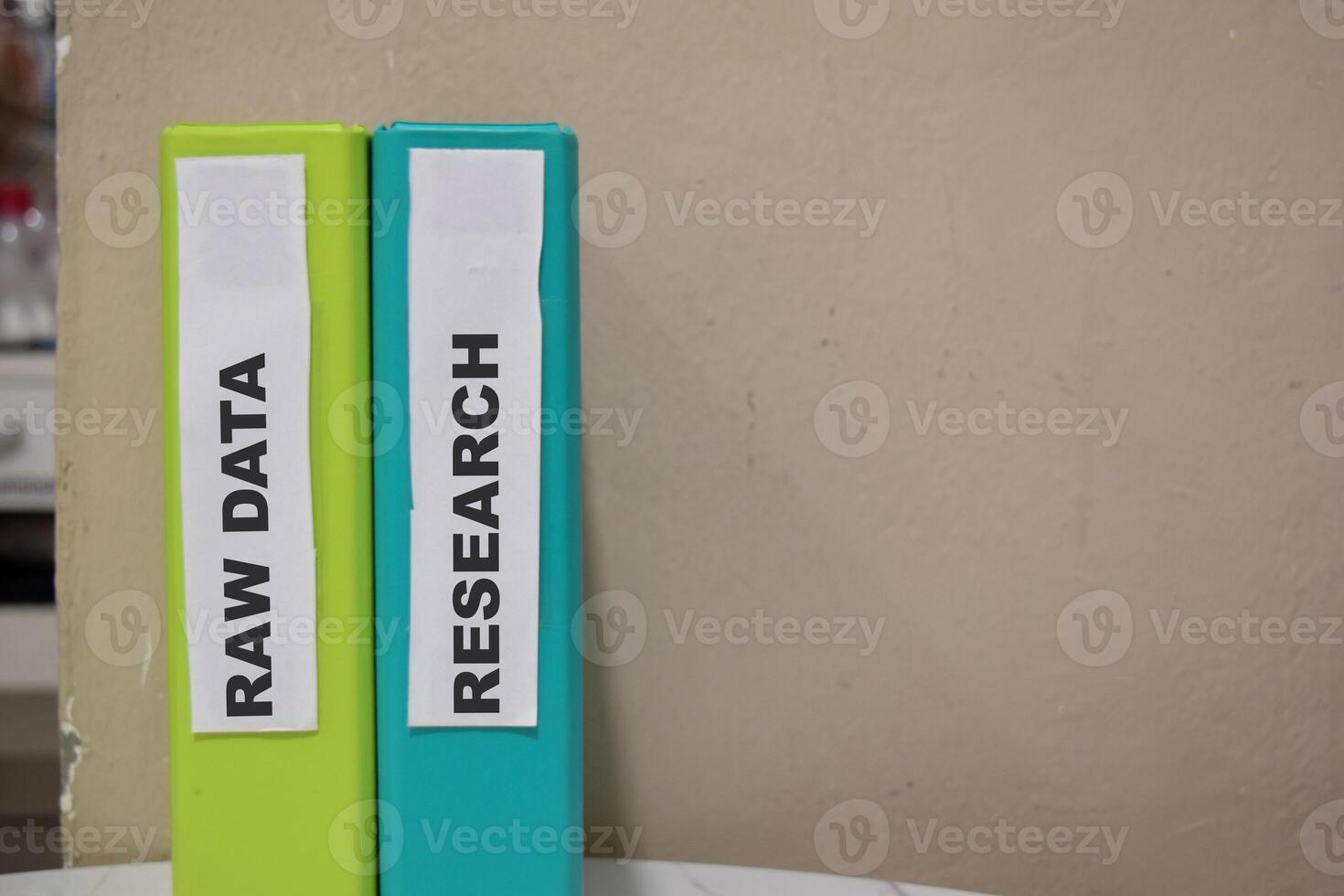 Folders with the label Raw data and research. Business management concept photo