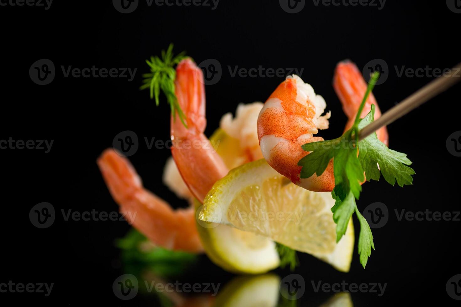 Still life of shrimps with lemon isolated on black background photo