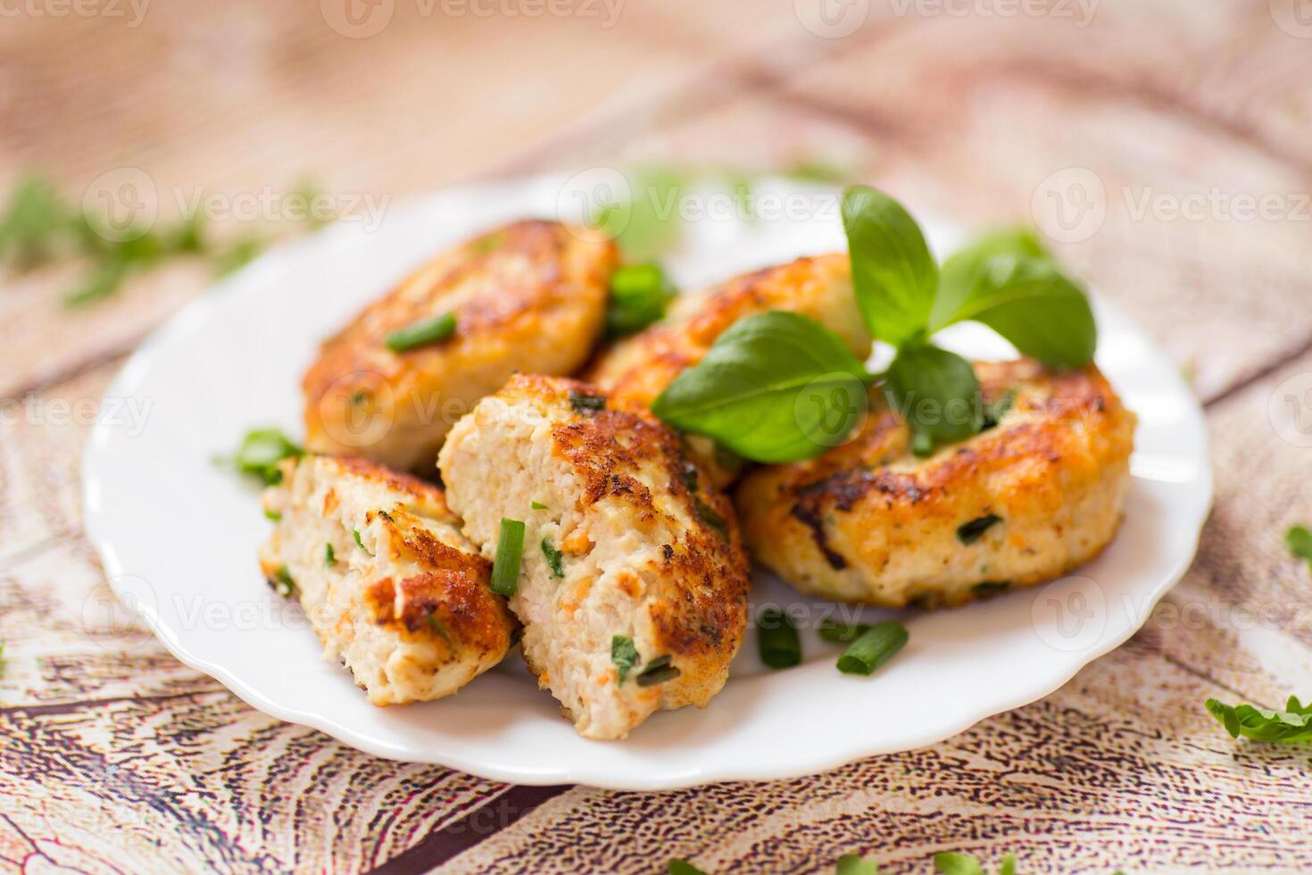 dinner of chicken cutlets with herbs, on a wooden table. photo