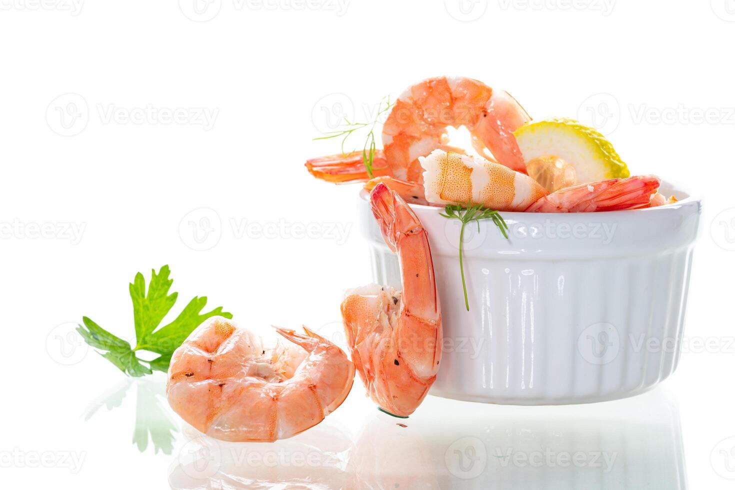 Boiled red shrimps with lemon on white background photo